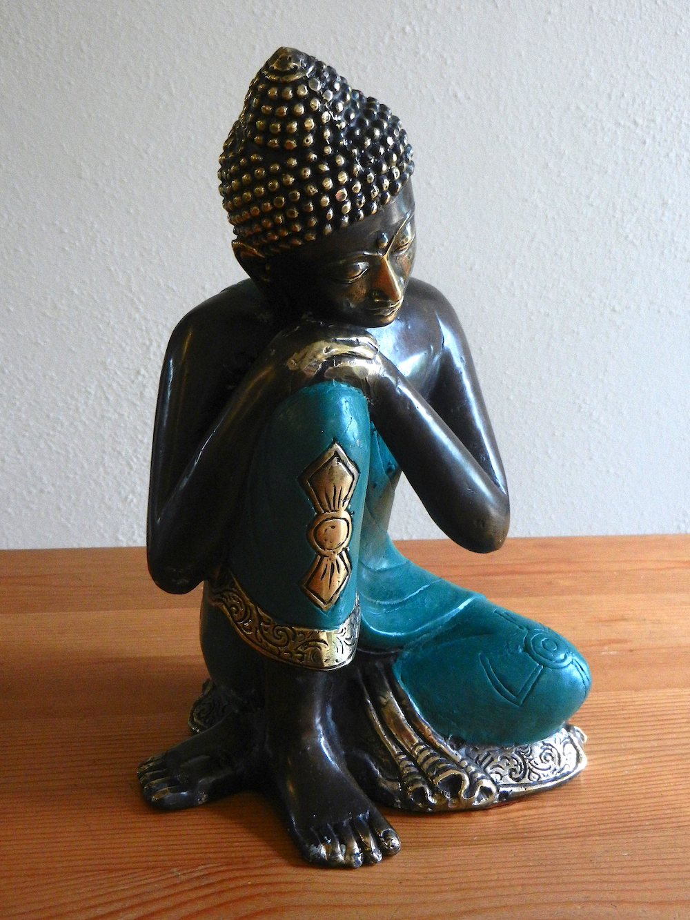 relaxing Buddha in green robe